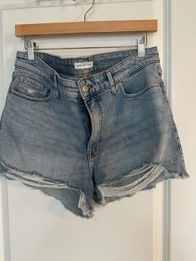 Good American Washed Light Blue Denim Cutoff Shorts